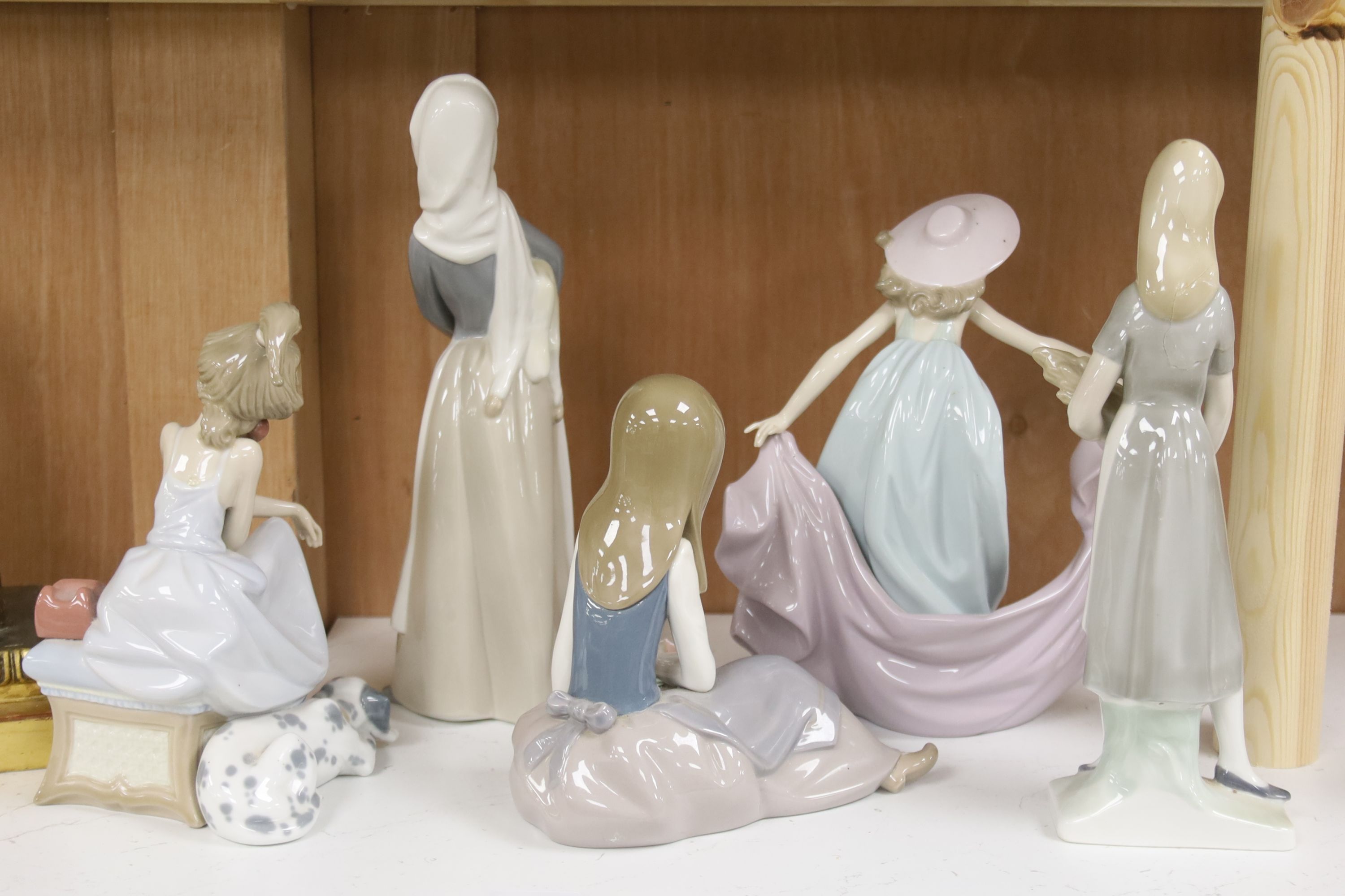 Four Lladro figurines and one Lladro style figurine, height 27cm